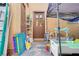 Outdoor patio area with multiple doors, a sun shade, and playsets on a concrete foundation at 5706 W Lake Mead Blvd, Las Vegas, NV 89108