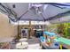 Outdoor covered patio area with a grill, table, and play area at 5706 W Lake Mead Blvd, Las Vegas, NV 89108