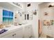 Bright bathroom featuring dual sinks, mirrors, and a beach-themed shower curtain at 5706 W Lake Mead Blvd, Las Vegas, NV 89108