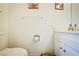 Simple bathroom with a toilet, sink, cabinet, and a decorated cushion at 5706 W Lake Mead Blvd, Las Vegas, NV 89108