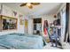 Comfortable bedroom featuring a ceiling fan, mounted TV, and functional furniture at 5706 W Lake Mead Blvd, Las Vegas, NV 89108