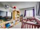 Cozy bedroom with a crib, a window with curtains, and neutral carpet at 5706 W Lake Mead Blvd, Las Vegas, NV 89108