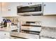 Stainless steel range and microwave combination and light countertops at 5706 W Lake Mead Blvd, Las Vegas, NV 89108