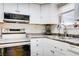 Bright kitchen featuring stainless steel appliances and white cabinetry at 5706 W Lake Mead Blvd, Las Vegas, NV 89108