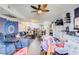 Bright living room with a ceiling fan, TV, and a view to the kitchen at 5706 W Lake Mead Blvd, Las Vegas, NV 89108