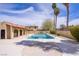 Community pool area featuring a large pool, palm trees, and adjacent building at 5706 W Lake Mead Blvd, Las Vegas, NV 89108