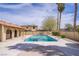 Community swimming pool with palm trees and a building in the background at 5706 W Lake Mead Blvd, Las Vegas, NV 89108