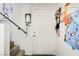 Carpeted stairwell leading to an upper level with a door and railing at 5706 W Lake Mead Blvd, Las Vegas, NV 89108