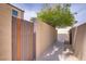 Residential walkway with block wall and wood fence on either side at 5706 W Lake Mead Blvd, Las Vegas, NV 89108