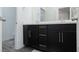 Elegant bathroom boasts dual sinks with black cabinets and modern fixtures at 600 N Carriage Hill Dr # 1081, Las Vegas, NV 89138