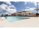 Community pool area with lounge chairs, umbrellas, and accessible entry at 600 N Carriage Hill Dr # 1081, Las Vegas, NV 89138