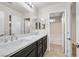 This bathroom features double sinks with a white countertop and dark cabinets at 6110 Scarlet Leaf St, Las Vegas, NV 89148