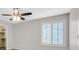 This bedroom features a ceiling fan, a window with shutters, and a walk-in closet at 6110 Scarlet Leaf St, Las Vegas, NV 89148