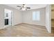 This bedroom has wood-look floors, ceiling fan, and a window with shutters at 6110 Scarlet Leaf St, Las Vegas, NV 89148