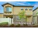 Charming two-story home featuring tan stucco, decorative stonework, and a well-manicured front yard at 6110 Scarlet Leaf St, Las Vegas, NV 89148