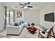 Cozy living room featuring modern furniture, a ceiling fan, and a sliding glass door at 6110 Scarlet Leaf St, Las Vegas, NV 89148