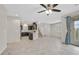Open concept living space with tiled floors connecting kitchen, living, and dining areas at 6110 Scarlet Leaf St, Las Vegas, NV 89148