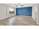 Main bedroom with wood floors, large windows and an accent wall at 6110 Scarlet Leaf St, Las Vegas, NV 89148