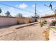 A spacious backyard featuring a block wall, trees, and access to covered patio at 6117 Borden Cir, Las Vegas, NV 89107