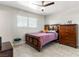 Bedroom featuring tile flooring, ceiling fan and stylish wooden furniture at 6117 Borden Cir, Las Vegas, NV 89107