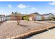 Cozy single-Gathering home with rock landscaping, mature trees, and a two-car attached garage at 6117 Borden Cir, Las Vegas, NV 89107