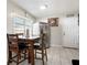 Eat-in kitchen showcasing stainless steel refrigerator, tiled floor, and modern lighting at 6117 Borden Cir, Las Vegas, NV 89107
