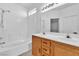 Bathroom featuring double sinks with wood cabinets, tub, shower and tile at 6329 Sandy Ridge St # 1, North Las Vegas, NV 89081
