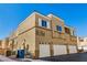 The exterior of a three-story building boasts multiple garages and unit numbers at 6329 Sandy Ridge St # 1, North Las Vegas, NV 89081