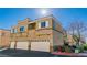 Modern stucco home with private garages, manicured shrubs, and a red fire hydrant at 6329 Sandy Ridge St # 1, North Las Vegas, NV 89081