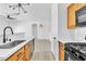 Kitchen with stainless sink, modern lighting and wooden cabinets at 6329 Sandy Ridge St # 1, North Las Vegas, NV 89081