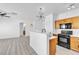 Open living space featuring a kitchen with wood cabinets and an eat-in breakfast bar at 6329 Sandy Ridge St # 1, North Las Vegas, NV 89081