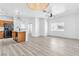 Spacious living room and kitchen area with modern lighting and laminate flooring at 6329 Sandy Ridge St # 1, North Las Vegas, NV 89081