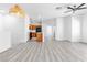 Bright living room with modern lighting fixtures and light wood-look floors at 6329 Sandy Ridge St # 1, North Las Vegas, NV 89081