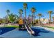 Well-maintained playground with play equipment and seating surrounded by landscaping at 6329 Sandy Ridge St # 1, North Las Vegas, NV 89081