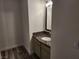 Bathroom sink with granite countertop and a wood-style floor at 7200 Pirates Cove Rd # 1014, Las Vegas, NV 89145