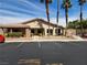 Beige clubhouse with tile roof, mature landscaping, and ample parking at 7200 Pirates Cove Rd # 1014, Las Vegas, NV 89145