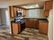 Updated kitchen boasts granite countertops, stainless appliances, and wood-look floors at 7200 Pirates Cove Rd # 1014, Las Vegas, NV 89145
