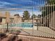 Community swimming pool area viewed through a metal fence at 7200 Pirates Cove Rd # 1014, Las Vegas, NV 89145