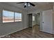 Bedroom with wood floors, a closet with mirrored sliding doors, and a window that provides ample sunlight at 722 Barrie Ct, Henderson, NV 89002