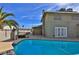 Inviting backyard pool with blue tile and clear water, perfect for relaxation and entertaining, complemented by mature palms at 722 Barrie Ct, Henderson, NV 89002