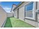 Side yard features a block wall and artificial grass at 7456 Cooks Meadow St, North Las Vegas, NV 89084