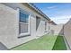 Cozy backyard space with artificial grass and a block wall at 7456 Cooks Meadow St, North Las Vegas, NV 89084