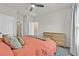 This bedroom features neutral walls, a ceiling fan, carpet floors and a wooden dresser at 7456 Cooks Meadow St, North Las Vegas, NV 89084