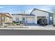 Single story home featuring desert landscaping, a two car garage and a covered porch entry at 7456 Cooks Meadow St, North Las Vegas, NV 89084