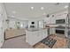 Open-concept kitchen featuring a kitchen island, granite countertops, and stainless steel appliances at 7456 Cooks Meadow St, North Las Vegas, NV 89084