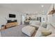 Open concept living room flows into the kitchen, offering a comfortable and stylish space for modern living at 7456 Cooks Meadow St, North Las Vegas, NV 89084