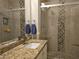 Modern bathroom featuring granite countertop, decorative tile accents, a glass shower, and updated fixtures at 75 N Valle Verde Dr # 1822, Henderson, NV 89074