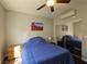 Bedroom with carpet, ceiling fan, mirror sliding doors, and bed with blue comforter and picture at 75 N Valle Verde Dr # 1822, Henderson, NV 89074