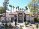 Community clubhouse entrance with lush landscaping and mature trees, creating a welcoming and serene atmosphere at 75 N Valle Verde Dr # 1822, Henderson, NV 89074