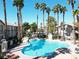 View of the community pool framed by towering palm trees and lush landscaping at 75 N Valle Verde Dr # 1822, Henderson, NV 89074